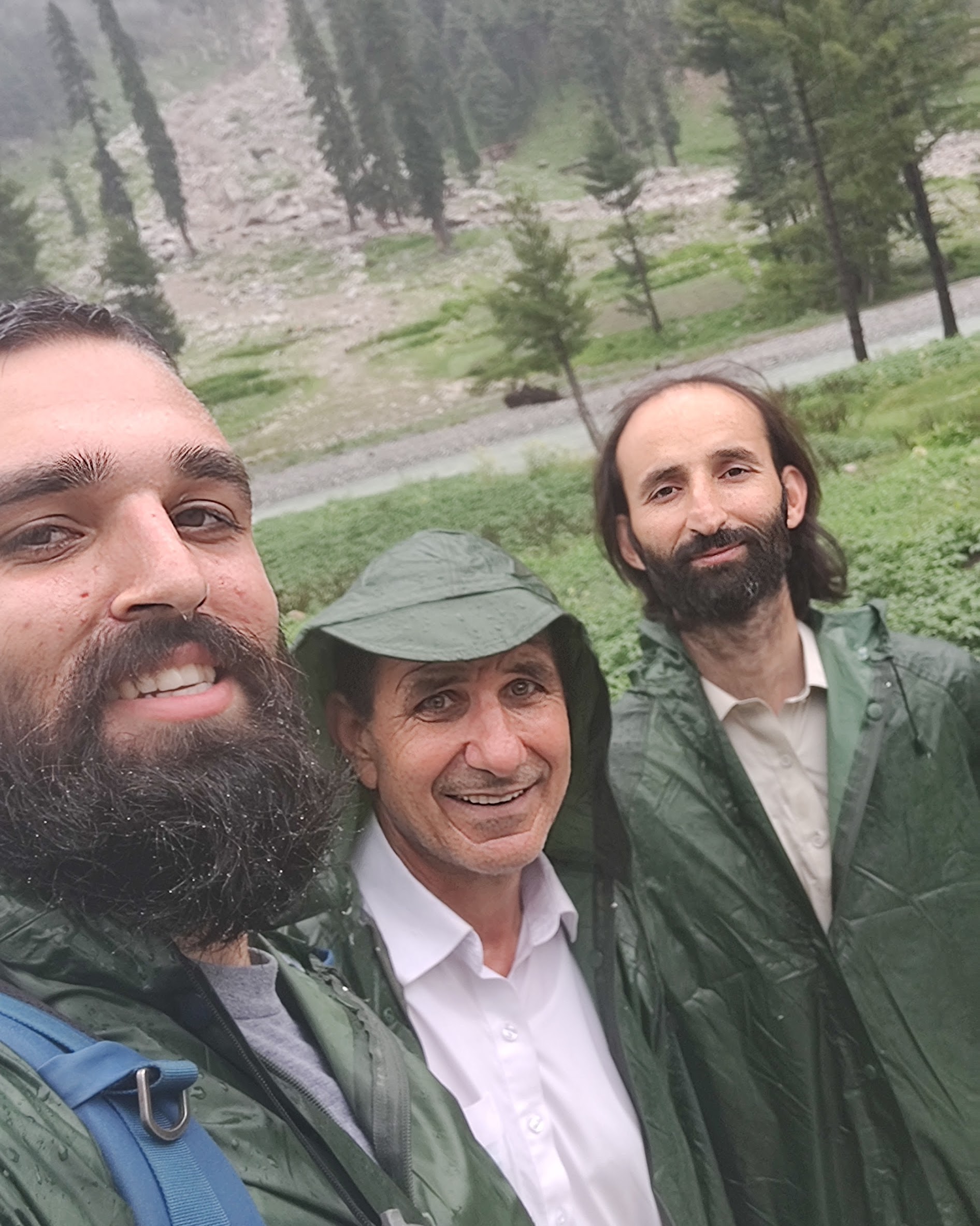selfie of 3men in raincoats